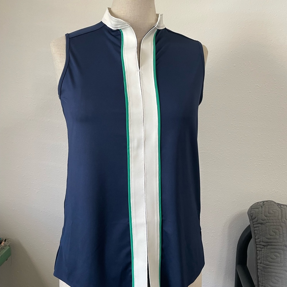 Preppy sleeveless blue golf shirt with white trim.